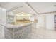 Charming kitchen featuring a breakfast bar, ample cabinet space, and tile flooring at 12099 Luxembourg Ct, Spring Hill, FL 34609