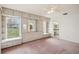 Spacious bedroom with built-in storage, pink carpet, ceiling fan, and view of outdoors at 12099 Luxembourg Ct, Spring Hill, FL 34609