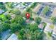 Aerial view of property amidst a neighborhood with lush greenery, close to parking and other buildings at 1262 Jeffords St, Clearwater, FL 33756
