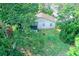 Back of house with screened porch and lawn, nestled amidst lush trees, creating a private outdoor space at 1262 Jeffords St, Clearwater, FL 33756