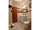 Bathroom featuring a vanity, toilet, tiled walls and floors, and a wall mirror at 1262 Jeffords St, Clearwater, FL 33756