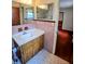 Bathroom view showcasing a vanity with sink, tiled walls and floor with access to the bedroom at 1262 Jeffords St, Clearwater, FL 33756