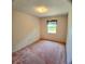 Empty bedroom filled with natural light, featuring wall-to-wall carpet, white walls and a window at 1262 Jeffords St, Clearwater, FL 33756