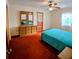 Spacious bedroom with a dresser, a bed with a blue bedspread, and natural light from the window at 1262 Jeffords St, Clearwater, FL 33756