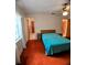Bedroom featuring a full bed, carpet floors, ceiling fan and natural lighting through the window at 1262 Jeffords St, Clearwater, FL 33756