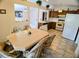 Dining area featuring tile floors and open access to the kitchen and living room at 1262 Jeffords St, Clearwater, FL 33756