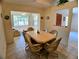 A cozy dining room featuring a table with six chairs, tile flooring, and natural light from windows at 1262 Jeffords St, Clearwater, FL 33756
