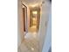 Hallway with tile flooring, access to rooms, and view of a bathroom with a vanity and mirror at 1262 Jeffords St, Clearwater, FL 33756