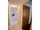 Hallway features tile floors and access to multiple rooms with a view of a bedroom with furniture at 1262 Jeffords St, Clearwater, FL 33756