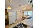 Kitchen featuring white appliances and an open layout to the dining area at 1262 Jeffords St, Clearwater, FL 33756