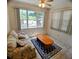 Bright living room with a comfortable floral sofa, wood coffee table, and area rug, illuminated by natural light at 1262 Jeffords St, Clearwater, FL 33756