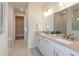 Modern bathroom with a double sink vanity, tiled floors, neutral color scheme, and a walk-in closet at 12626 Glenn Creek Dr, Riverview, FL 33569