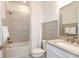 Well-lit bathroom with a shower and bathtub, featuring modern fixtures and a clean, neutral color palette at 12626 Glenn Creek Dr, Riverview, FL 33569