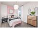 Charming bedroom with a pink accent wall, stylish furnishings, and a comfortable bed at 12626 Glenn Creek Dr, Riverview, FL 33569
