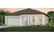 Charming single-story home featuring a neutral color palette, well-manicured lawn, and an attached two-car garage at 12626 Glenn Creek Dr, Riverview, FL 33569