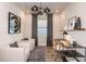 Bright home office featuring two comfortable armchairs, a modern desk setup, and stylish lighting fixtures at 12626 Glenn Creek Dr, Riverview, FL 33569