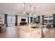 Open-concept kitchen with stainless steel appliances, center island with seating, and views of the living and dining areas at 12626 Glenn Creek Dr, Riverview, FL 33569