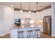 Spacious kitchen featuring an island with seating, quartz countertops, stainless steel appliances, and stylish pendant lights at 12626 Glenn Creek Dr, Riverview, FL 33569