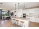 Well-lit kitchen and dining area with hardwood floors, quartz countertops, pendant lighting, and stainless steel appliances at 12626 Glenn Creek Dr, Riverview, FL 33569