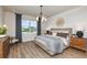 Serene main bedroom with a large window, modern light fixture, and a light neutral color palette at 12626 Glenn Creek Dr, Riverview, FL 33569
