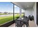 Relaxing screened patio with outdoor seating, offering serene views of the lush landscape and a pond at 12626 Glenn Creek Dr, Riverview, FL 33569