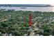 Aerial view of the neighborhood featuring lush trees and distant water at 1267 Woodlawn Ter, Clearwater, FL 33755