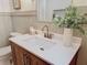 Bathroom featuring a wood vanity with white countertop, and stylish gold fixtures at 1267 Woodlawn Ter, Clearwater, FL 33755