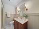 Bathroom featuring a wood vanity with white countertop, and shower with updated fixtures and stylish lighting at 1267 Woodlawn Ter, Clearwater, FL 33755