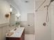 Modern bathroom featuring a stylish vanity with gold fixtures and a tiled shower with gold accents at 1267 Woodlawn Ter, Clearwater, FL 33755