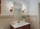 Bathroom featuring a wood vanity with white countertop, and stylish lighting and fixtures at 1267 Woodlawn Ter, Clearwater, FL 33755