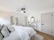 Bedroom featuring natural light, two doors, stylish decor, ceiling fan, and a comfortable bed with textured throw at 1267 Woodlawn Ter, Clearwater, FL 33755