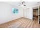 Bedroom featuring hardwood floors, a closet, and an open door at 1267 Woodlawn Ter, Clearwater, FL 33755