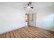 Unfurnished bedroom with hardwood floors and ceiling fan, showcasing a minimalist design and natural light at 1267 Woodlawn Ter, Clearwater, FL 33755