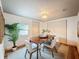 Inviting dining room with a wooden table, stylish chairs, rug, and natural light at 1267 Woodlawn Ter, Clearwater, FL 33755