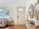 Bright entryway with modern decor, a stylish console table, and a view into the living area at 1267 Woodlawn Ter, Clearwater, FL 33755