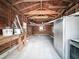 Interior view of the garage with old refrigerator and debris at 1267 Woodlawn Ter, Clearwater, FL 33755