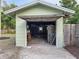 Open garage with overhead roof and some debris at 1267 Woodlawn Ter, Clearwater, FL 33755