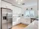 Bright kitchen featuring stainless steel appliances, white cabinets and a farmhouse sink at 1267 Woodlawn Ter, Clearwater, FL 33755