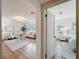 Open-concept living room with modern decor, hardwood floors, and an open doorway to the bedroom at 1267 Woodlawn Ter, Clearwater, FL 33755