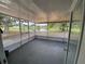 Screened-in back porch with a serene view of the lake and yard at 12912 Leadwood Dr, Riverview, FL 33579