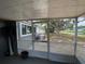 Screened-in back porch with a view of the backyard and lake in the distance at 12912 Leadwood Dr, Riverview, FL 33579
