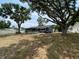 Spacious backyard with mature trees providing ample shade to the back of the house at 12912 Leadwood Dr, Riverview, FL 33579