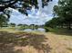 Beautiful backyard featuring a calming lake view surrounded by mature trees at 12912 Leadwood Dr, Riverview, FL 33579