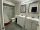 Stylish bathroom featuring dual sinks, modern fixtures, and a walk-in shower at 12912 Leadwood Dr, Riverview, FL 33579