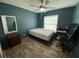Cozy bedroom featuring hardwood floors and a ceiling fan with great natural light at 12912 Leadwood Dr, Riverview, FL 33579