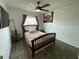 Bedroom with hardwood floors, ceiling fan, large picture, and window with curtains at 12912 Leadwood Dr, Riverview, FL 33579