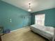 Bedroom with hardwood floors, a hanging light fixture, and butterfly wall decals at 12912 Leadwood Dr, Riverview, FL 33579