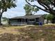 Exterior view of the home from the backyard, featuring a screened-in porch at 12912 Leadwood Dr, Riverview, FL 33579