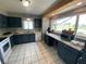 Kitchen featuring granite counters, tile floors and a great view of the lake at 12912 Leadwood Dr, Riverview, FL 33579