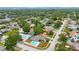 A high angle view of a quiet residential area with manicured lawns, tree coverage and backyard pools at 13563 Cordova Dr, Largo, FL 33774
